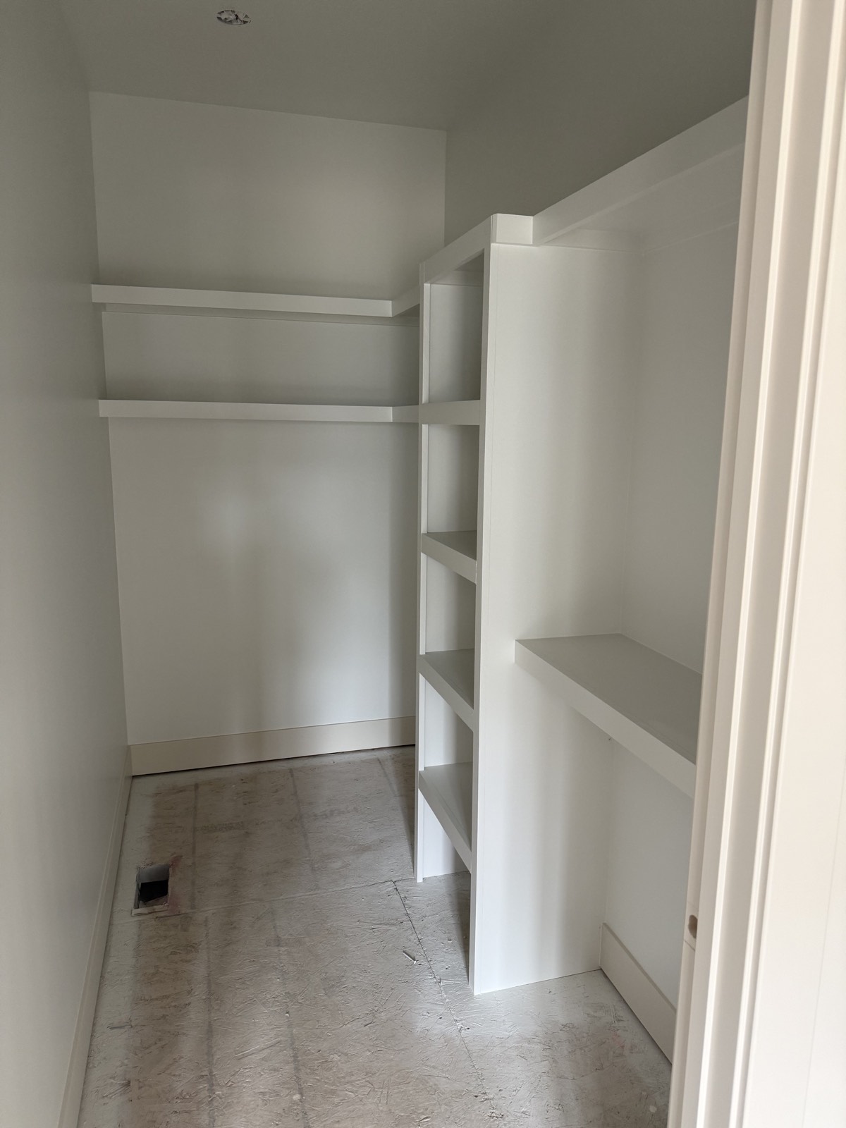 Custom white built-in shelving and finish work by LNK Painting