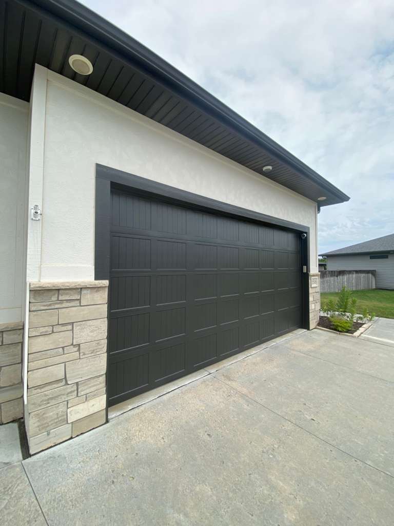 Freshly painted exterior garage door and trim by LNK Painting
